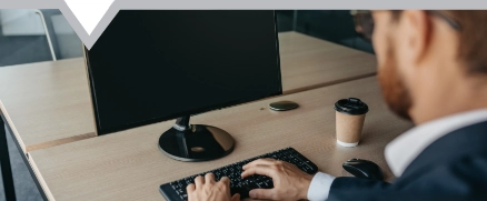 Business man using a computer in a office typing on a computer