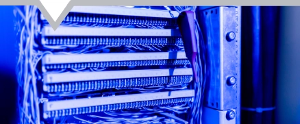 patch network cables sorted in a rack cabinet leading from a patch panel in a server rack